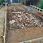 Breaking rock layer by layer for pool excavation in North Texas